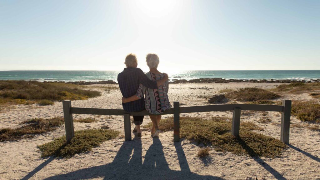 Couple enjoying retirement at a beach abroad from Ireland