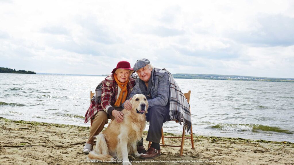 old couple with a dog at the beach in retirement